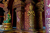 Chiang Mai - The Wat Phra Singh temple. The ubosot (ordination hall). Detail of the ku, a large ornate Buddha throne that sits in the middle of the building. 